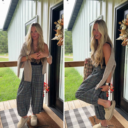 Woman wearing the Boho plaid balloon pants in Dark Forest on a fall porch, elastic cuff at the ankle