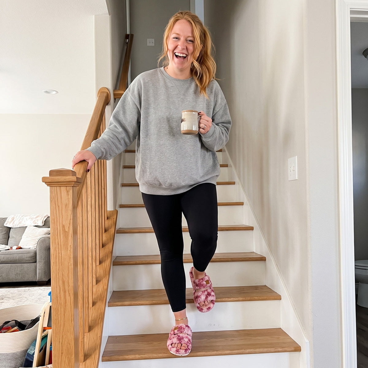 Woman wearing Fuzzy slides in Diva Wild Pink at home