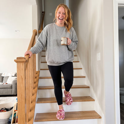 Woman wearing Fuzzy slides in Diva Wild Pink at home