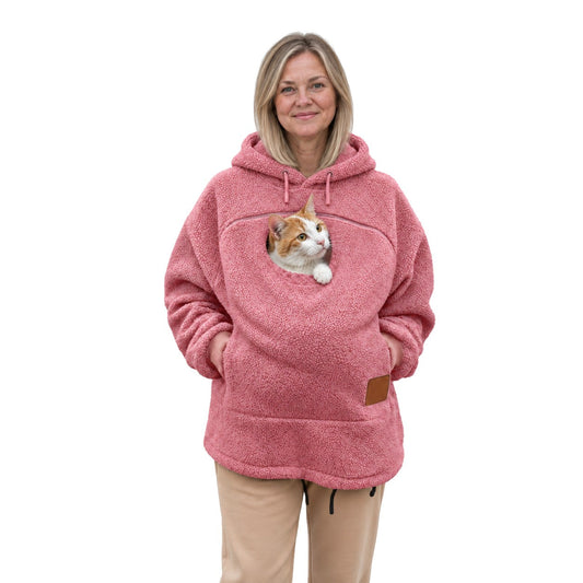 Meowdie cat pocket hoodie in Pink, a real cat resting in the zip pouch