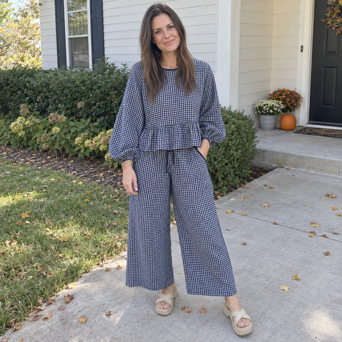 Woman wearing the Peppy gingham set in Navy outside her home