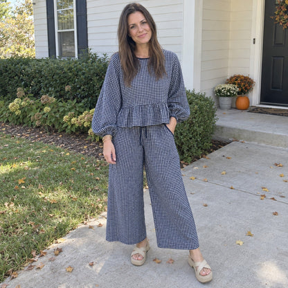 Woman wearing the Peppy gingham set in Navy outside her home