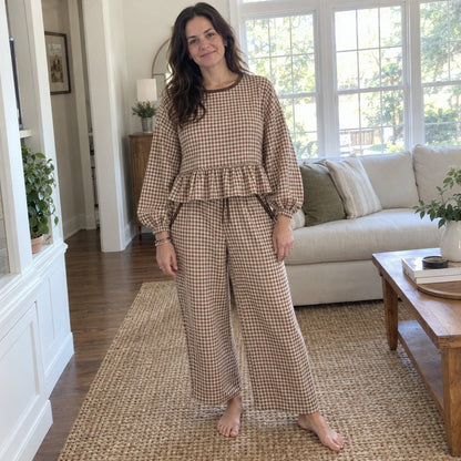 Woman wearing the Peppy gingham set in Brown in her living room