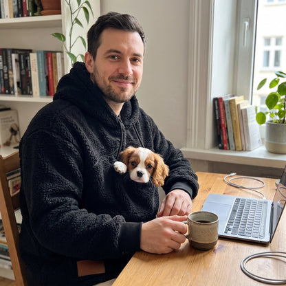 Working from home in the Woofdie in Black, Cavalier King Charles puppy in the pouch
