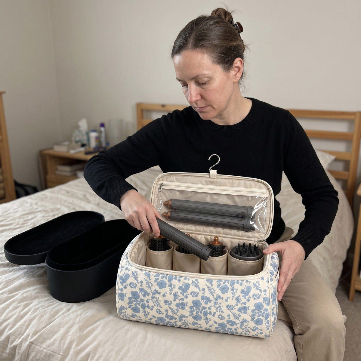 Woman packing her styler into the Wrappy bag next to the bulky hard case
